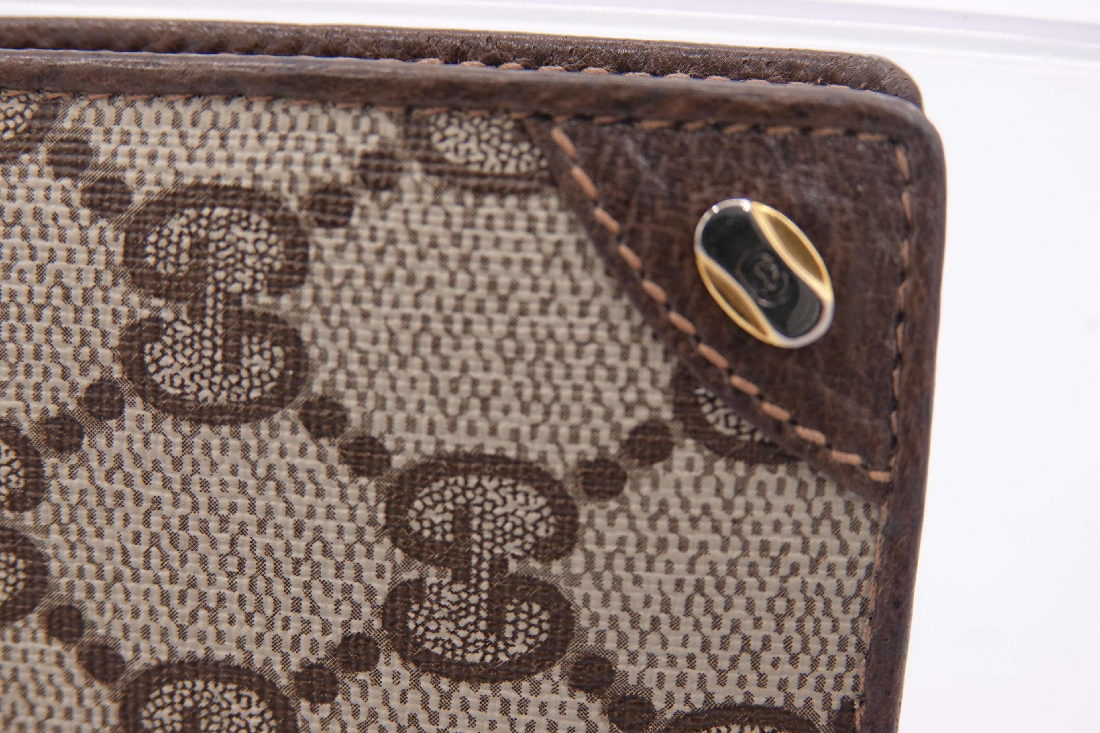 Close-up of a Gucci wallet with brown monogram pattern