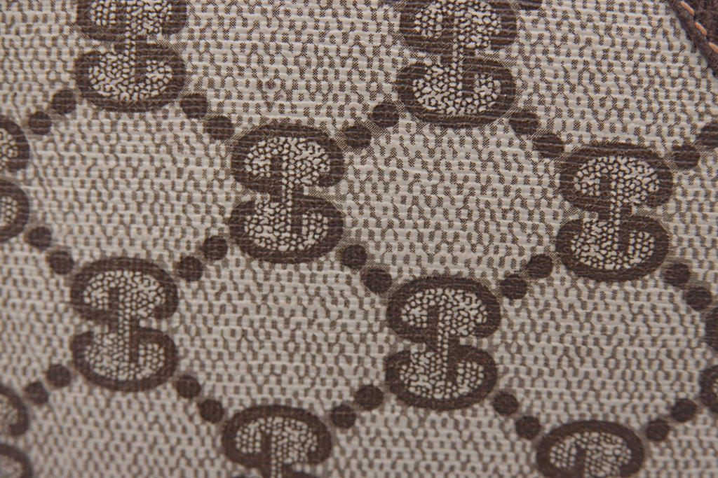 Close-up of a patterned fabric with a repeated design.