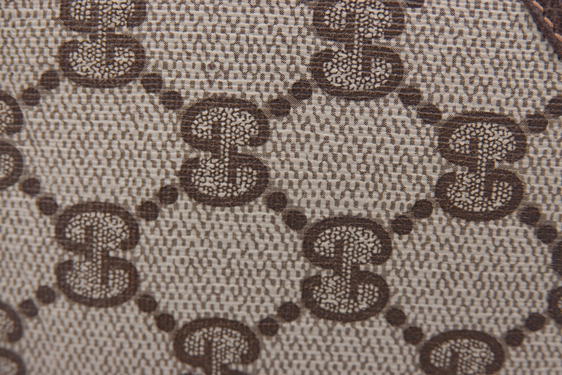 Close-up of a patterned fabric with a repeated design.