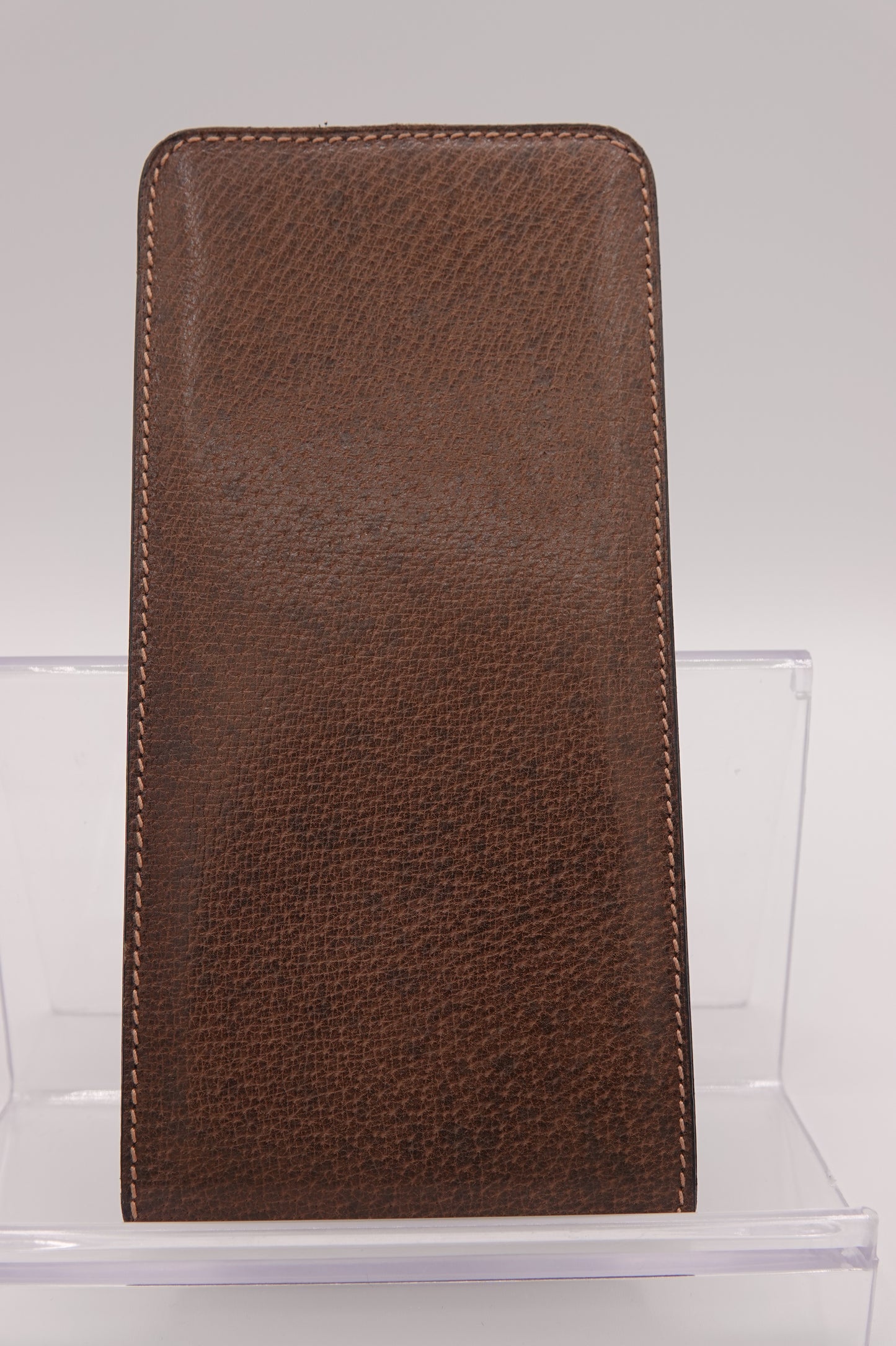 Brown leather wallet on a clear stand against a white background