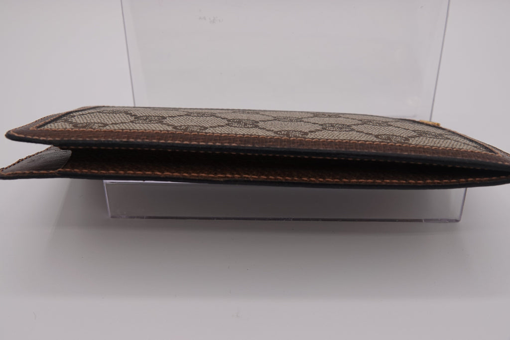 Brown leather clutch with pattern on a white background