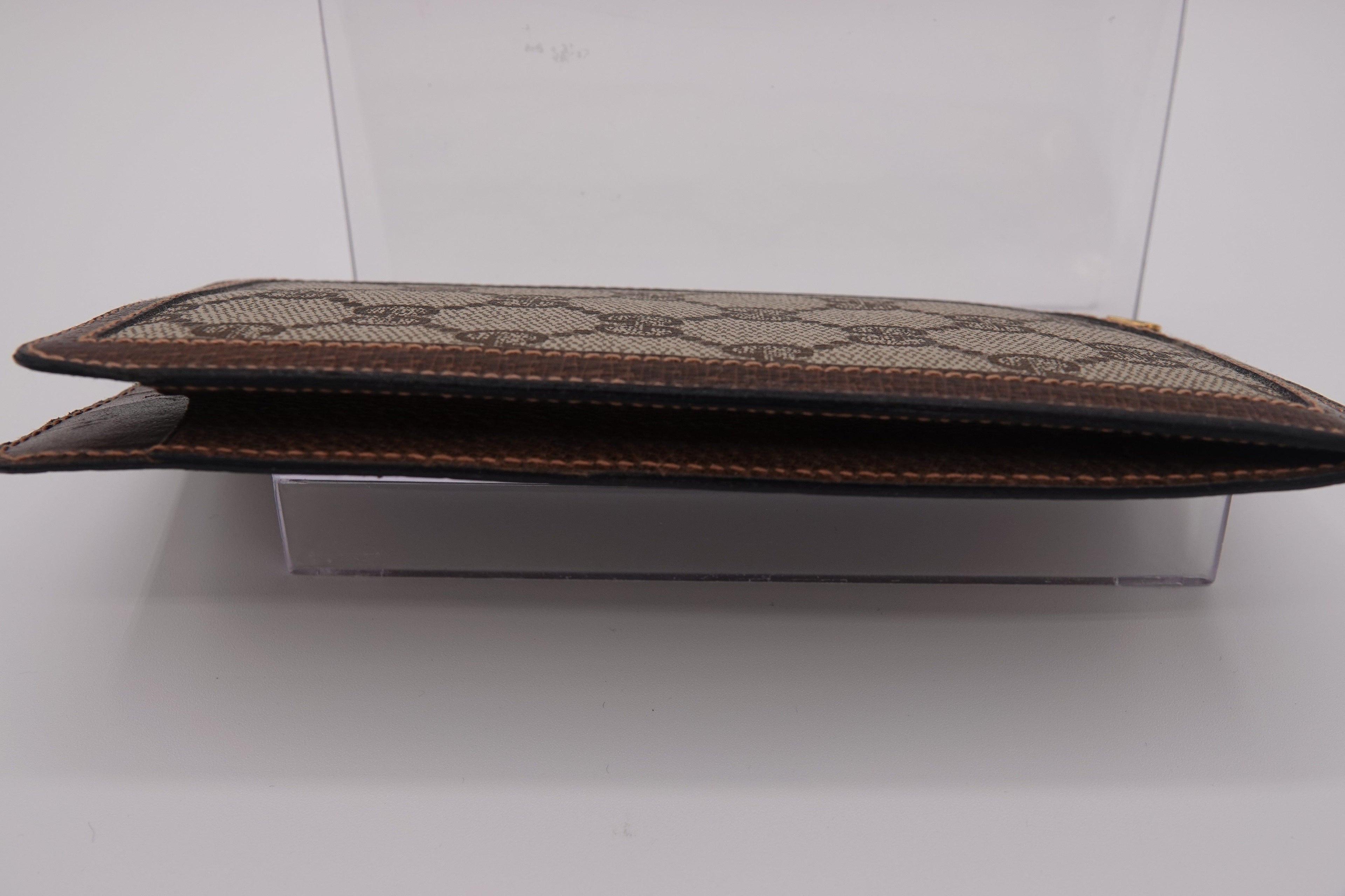 Brown leather clutch with pattern on a white background