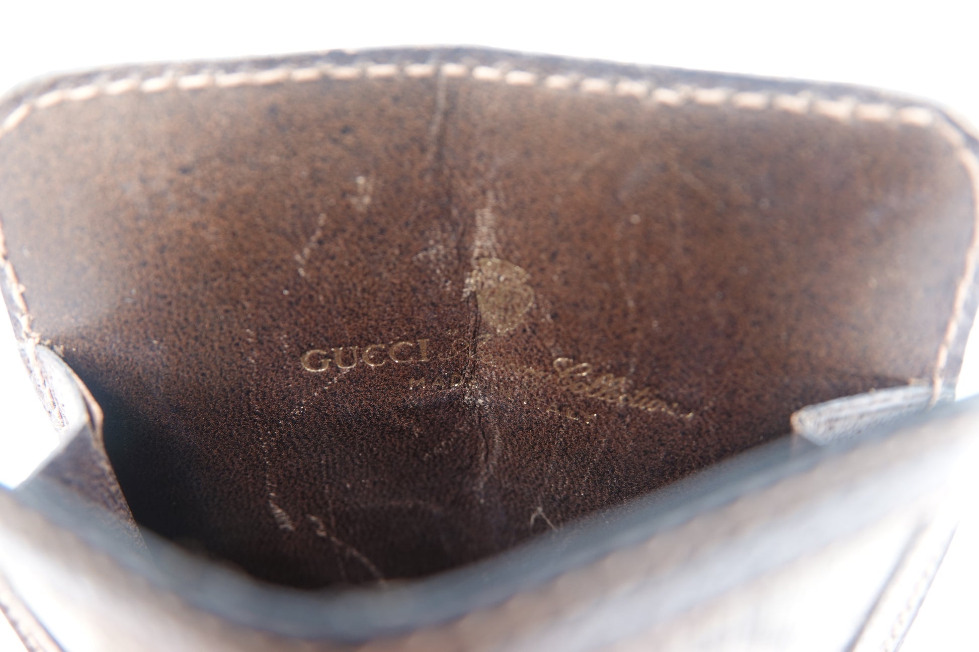 Close-up of a Gucci handbag with visible wear and tear.