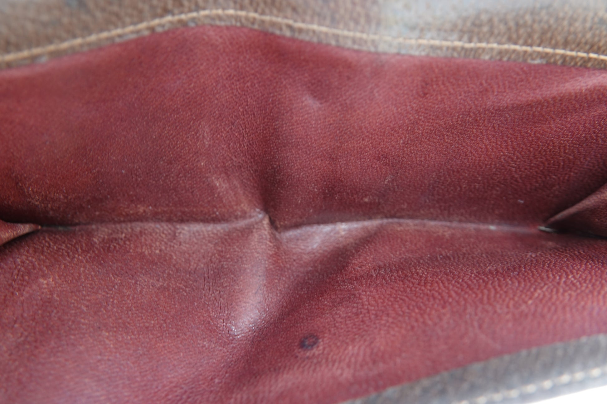 Close-up of a brown leather glove with visible wear.