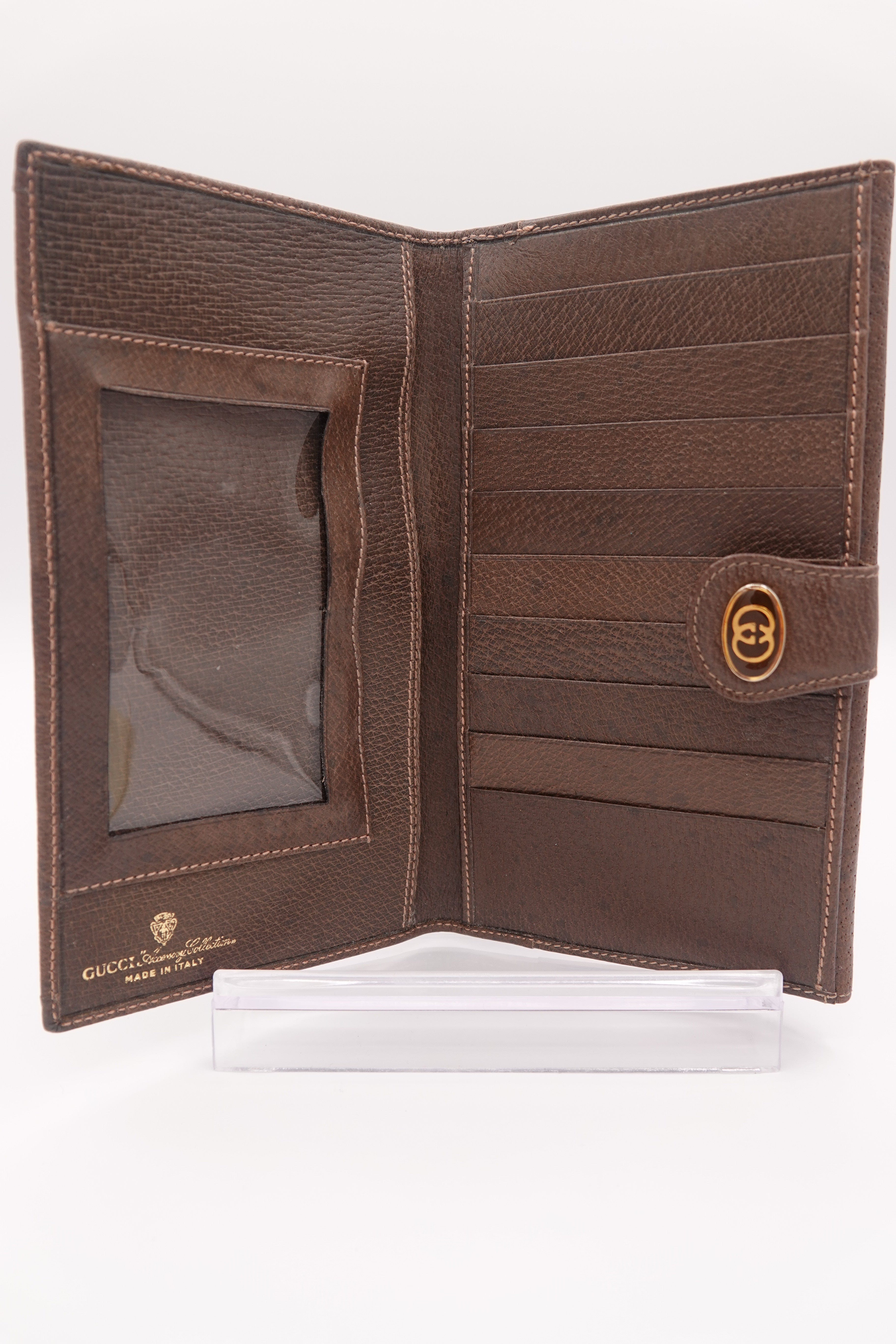 Brown leather wallet with a visible brand logo on a white background