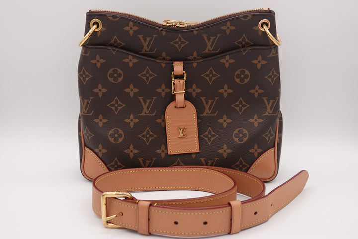 Designer handbag with monogram pattern on a white background