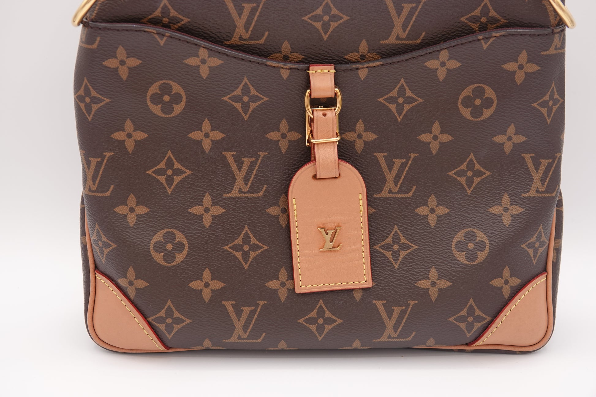 Louis Vuitton monogram handbag with a visible tag on a white background