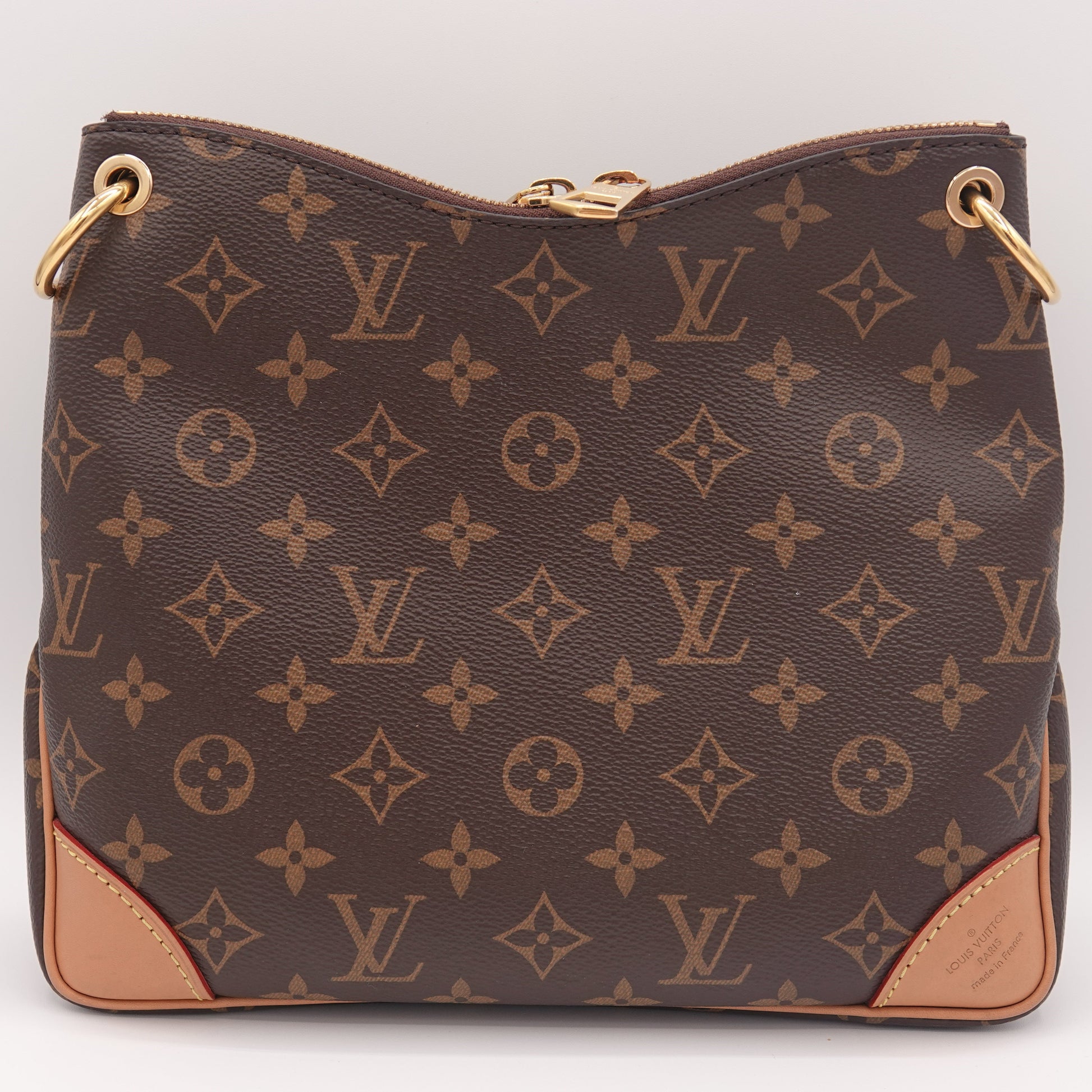Brown handbag with a prominent pattern on a white background