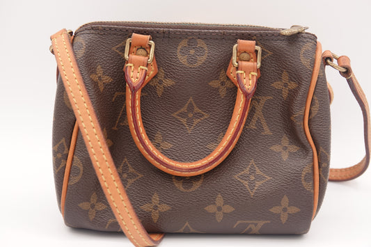 Brown handbag with monogram pattern on a white background