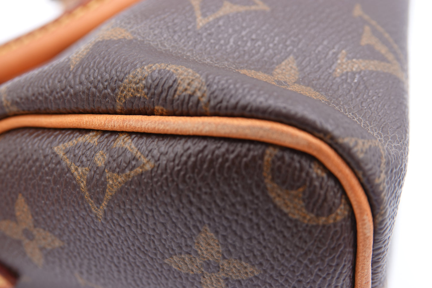 Close-up of a brown Louis Vuitton handbag with monogram pattern.