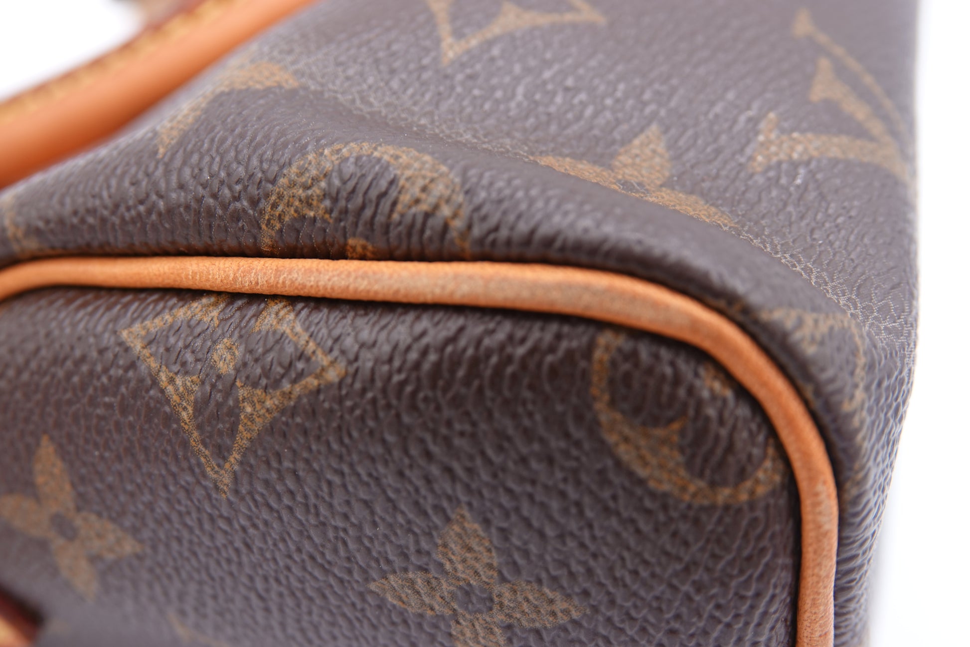 Close-up of a brown Louis Vuitton handbag with monogram pattern.