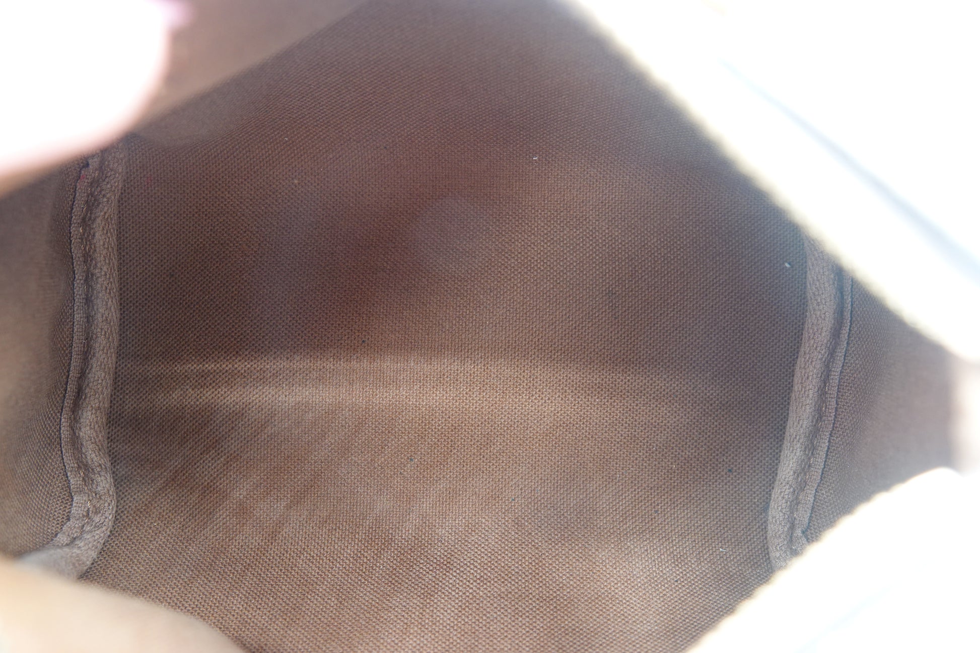 Close-up of a brown shoe sole with visible wear and tear.