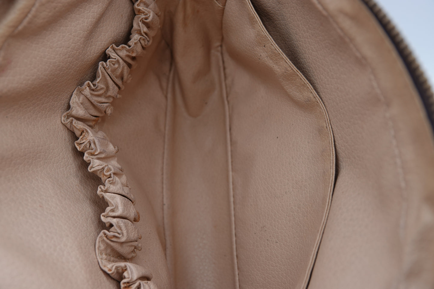 Close-up of a beige fabric with ruffled trim