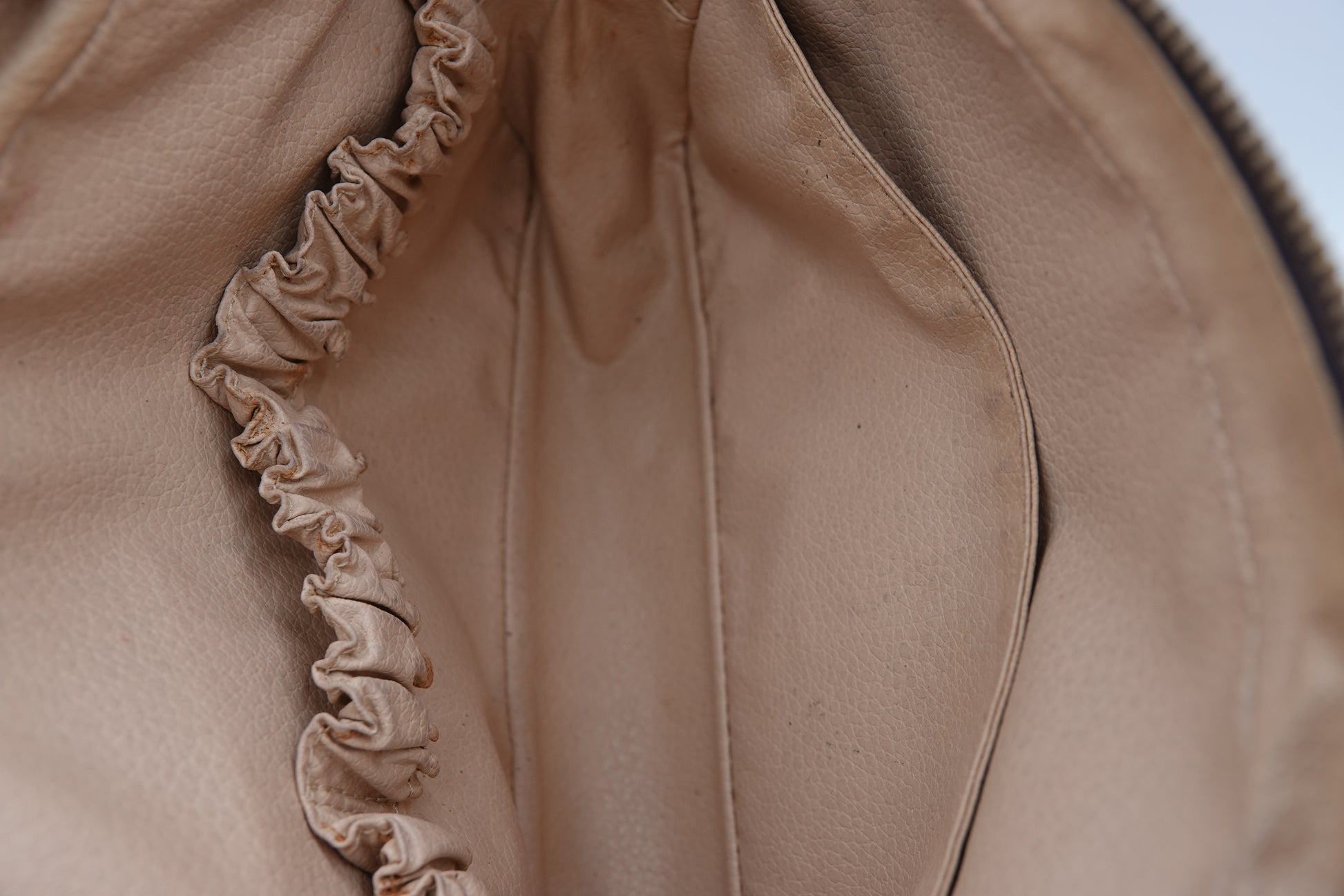 Close-up of a beige fabric with ruffled trim