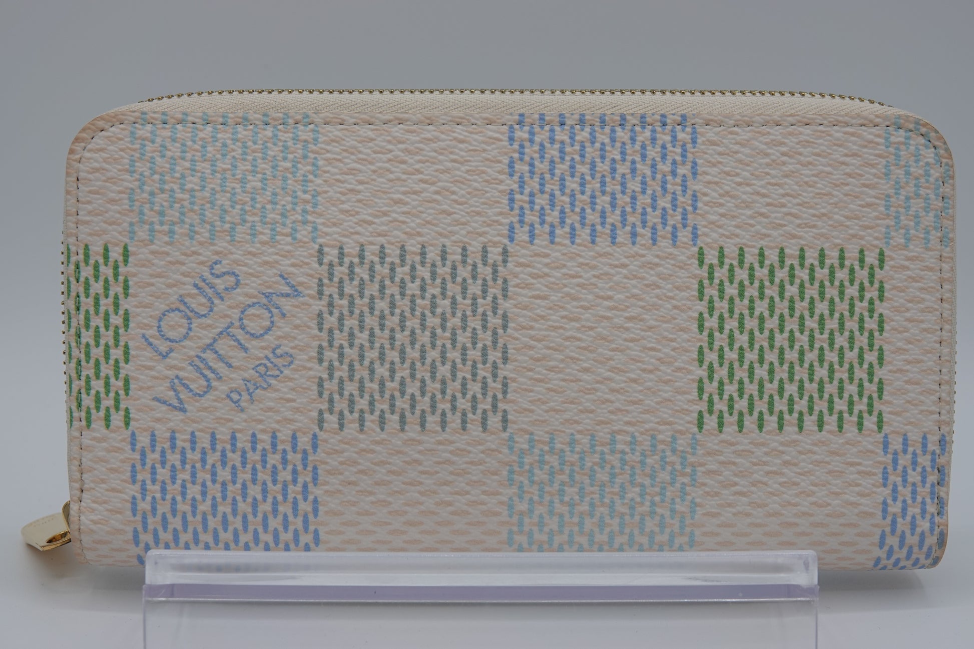 Louis Vuitton wallet with a checkered pattern on a gray background