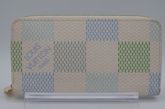 Louis Vuitton wallet with a checkered pattern on a gray background