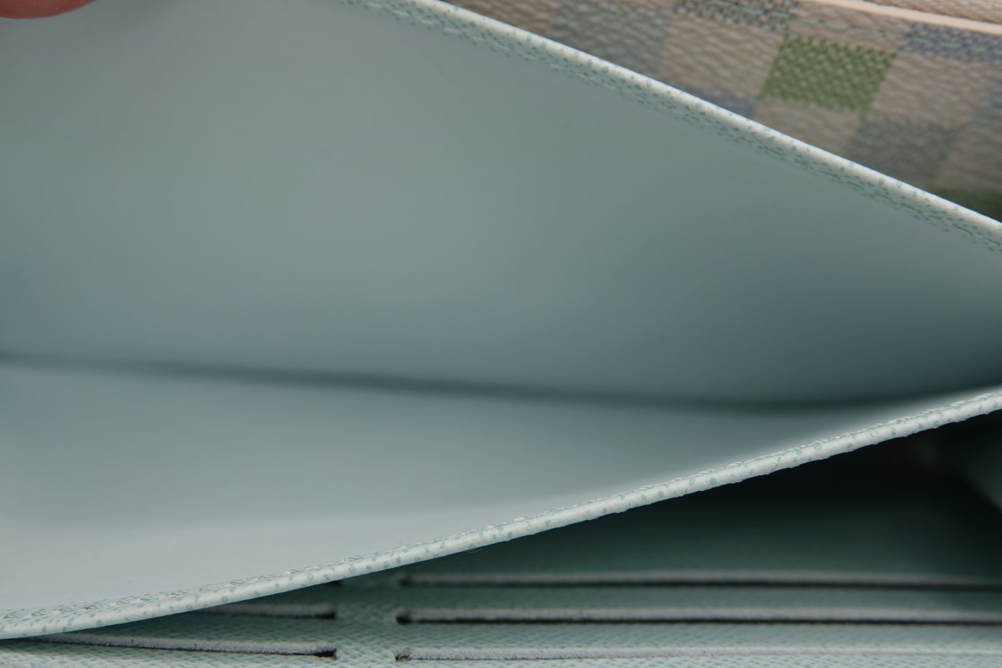 Close-up of a textured surface with a patterned fabric background