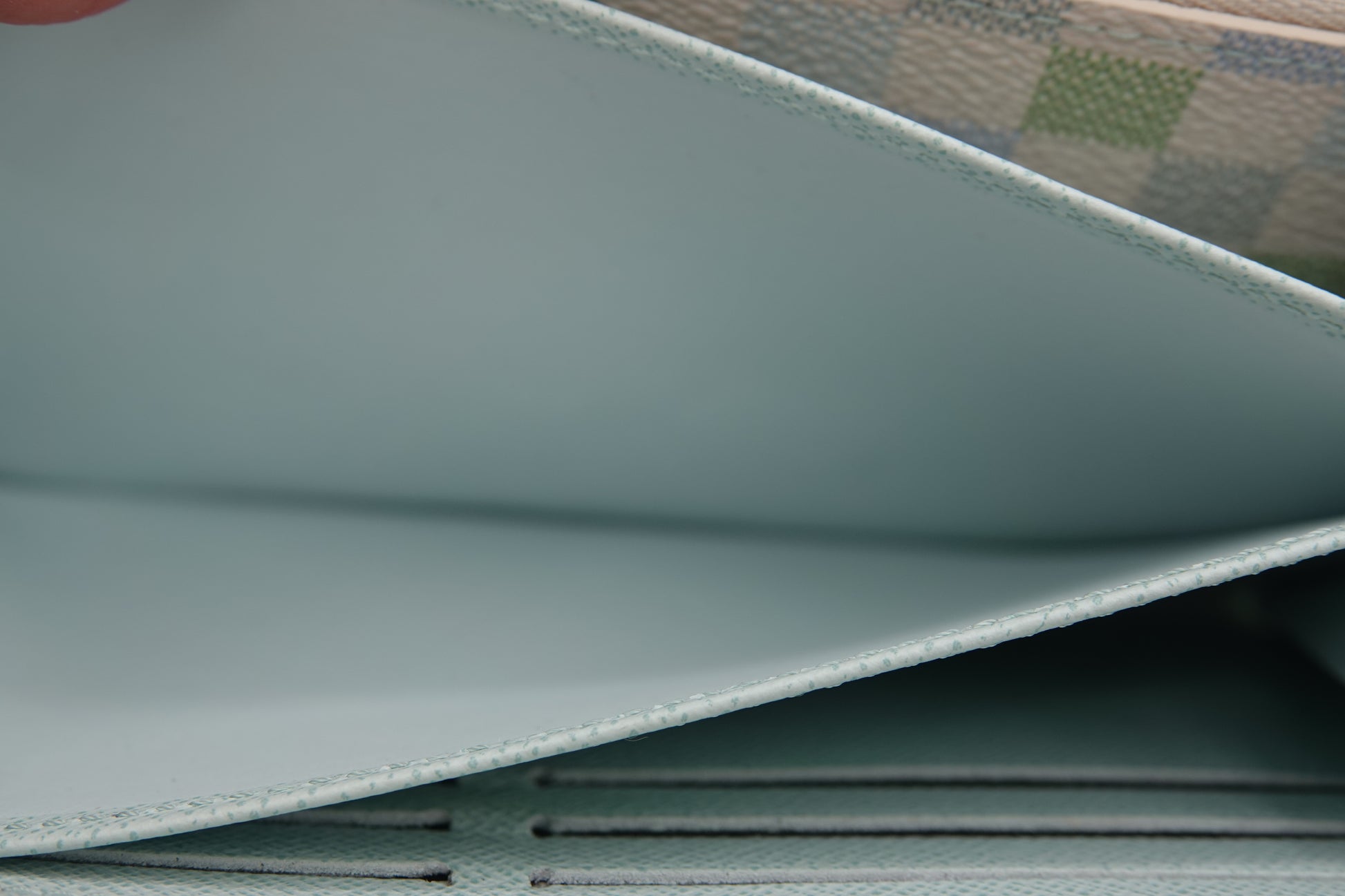 Close-up of a textured surface with a patterned fabric background