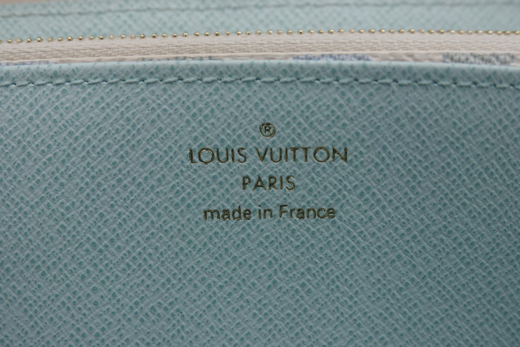 Louis Vuitton logo on a textured blue surface