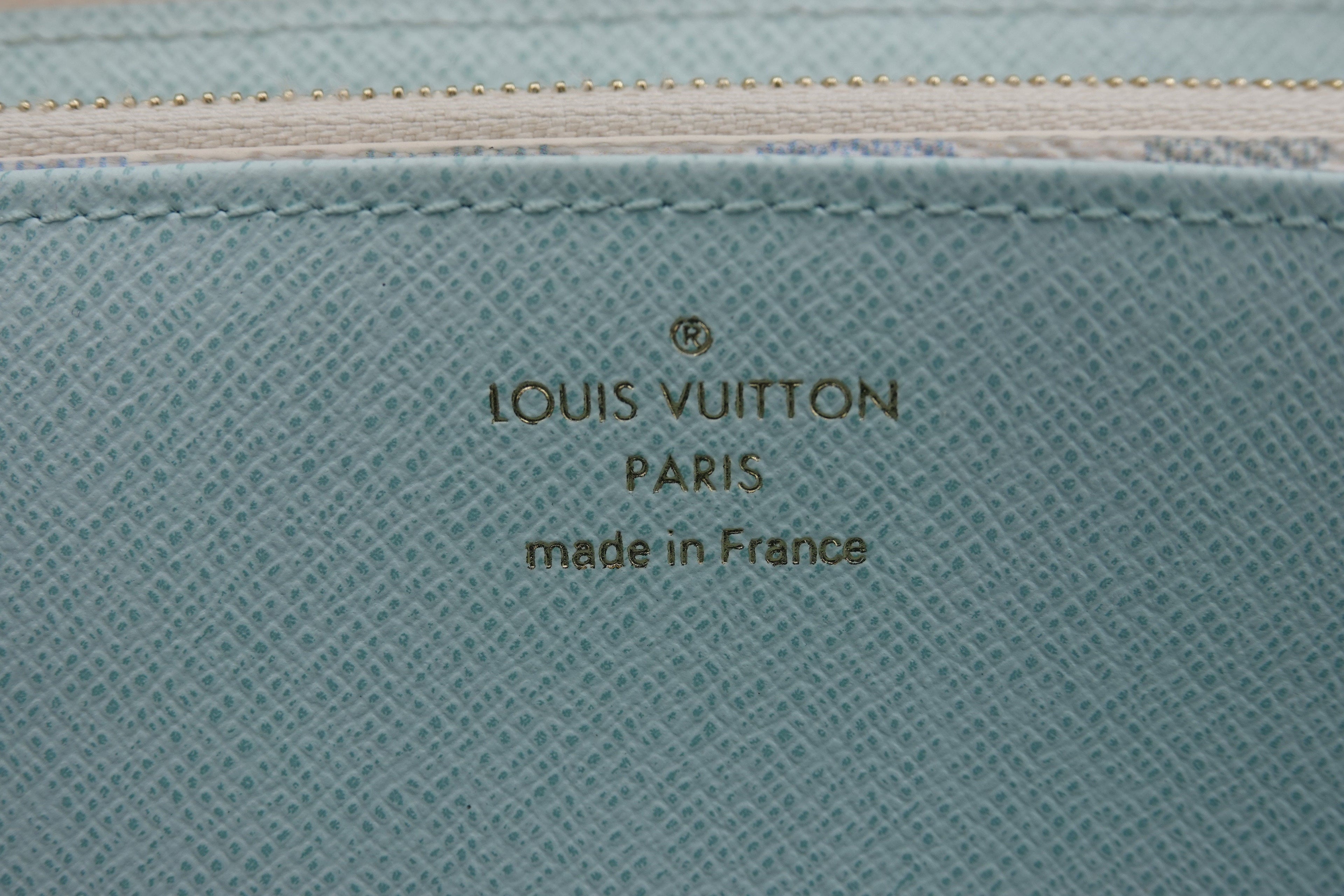 Louis Vuitton logo on a textured blue surface