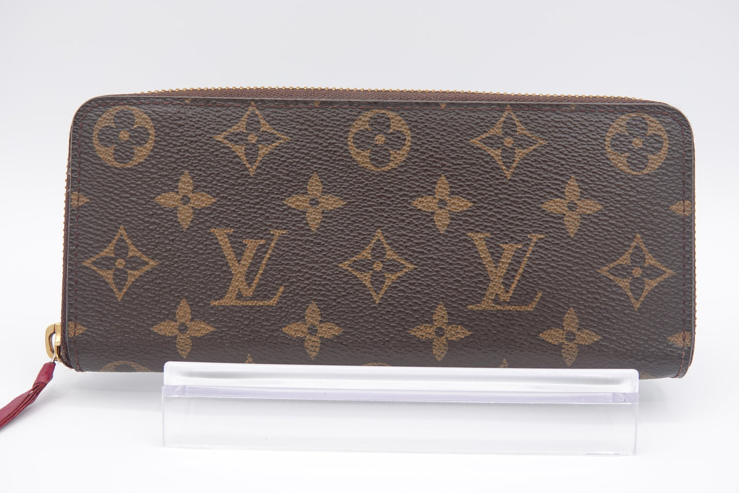 Louis Vuitton wallet with monogram pattern on a white background