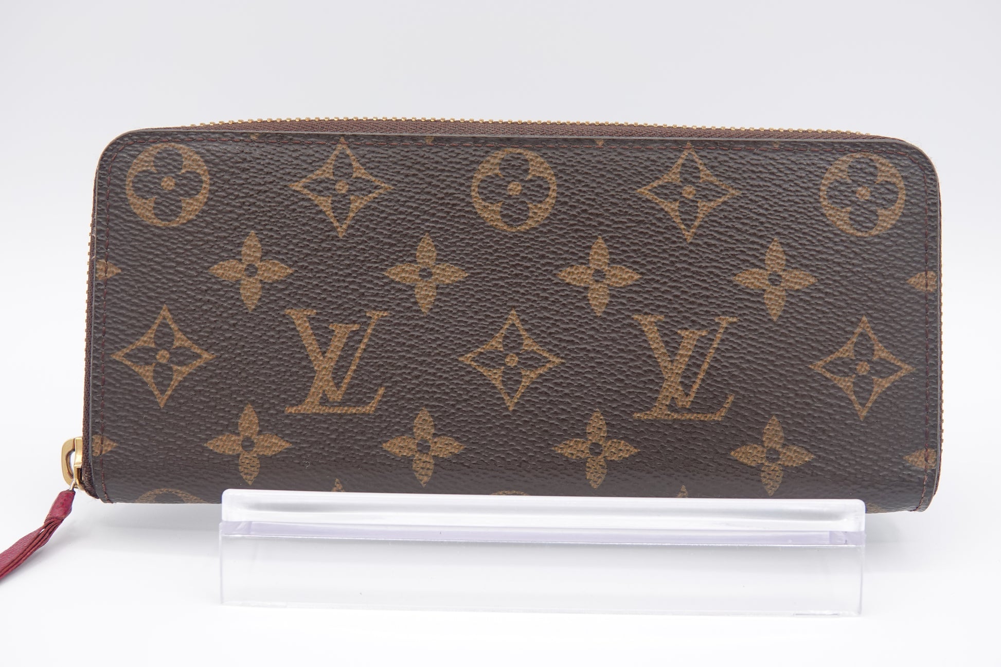 Louis Vuitton wallet with monogram pattern on a white background