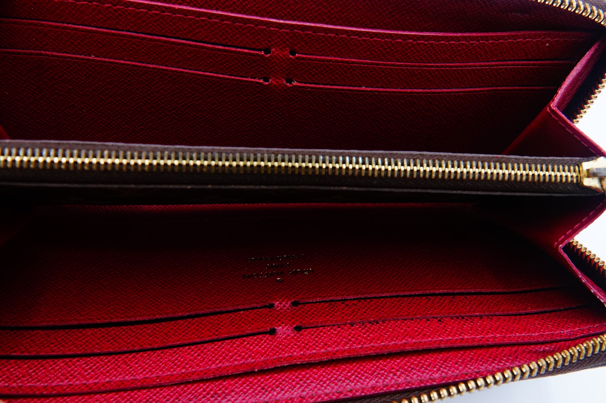Close-up of a red wallet with a gold zipper