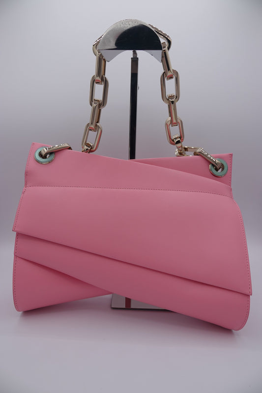 Pink handbag with a chain handle on a light gray background