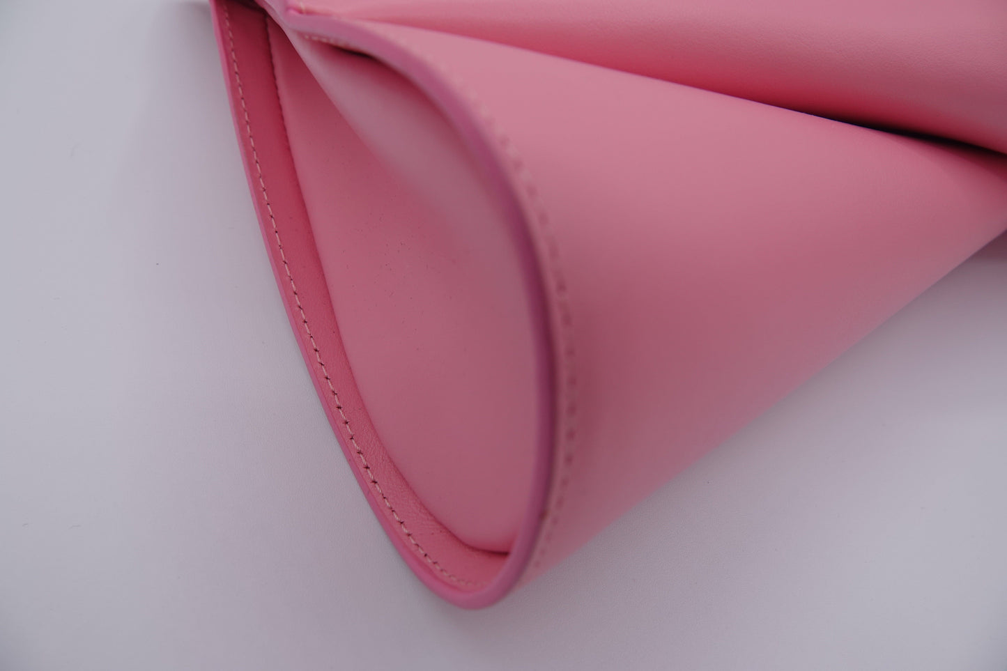 Close-up of a pink leather product on a white background