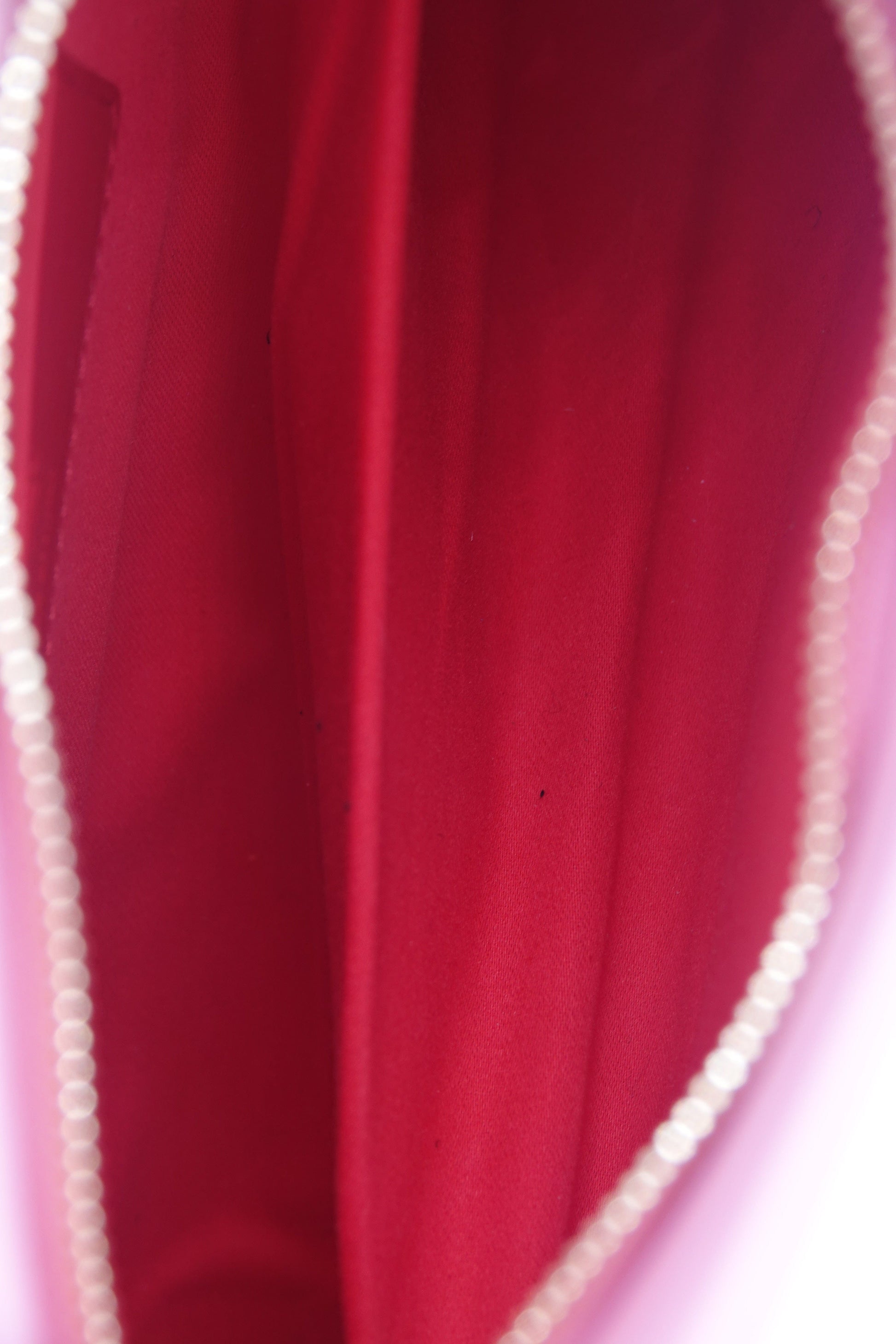 Close-up of a red fabric surface with a zipper