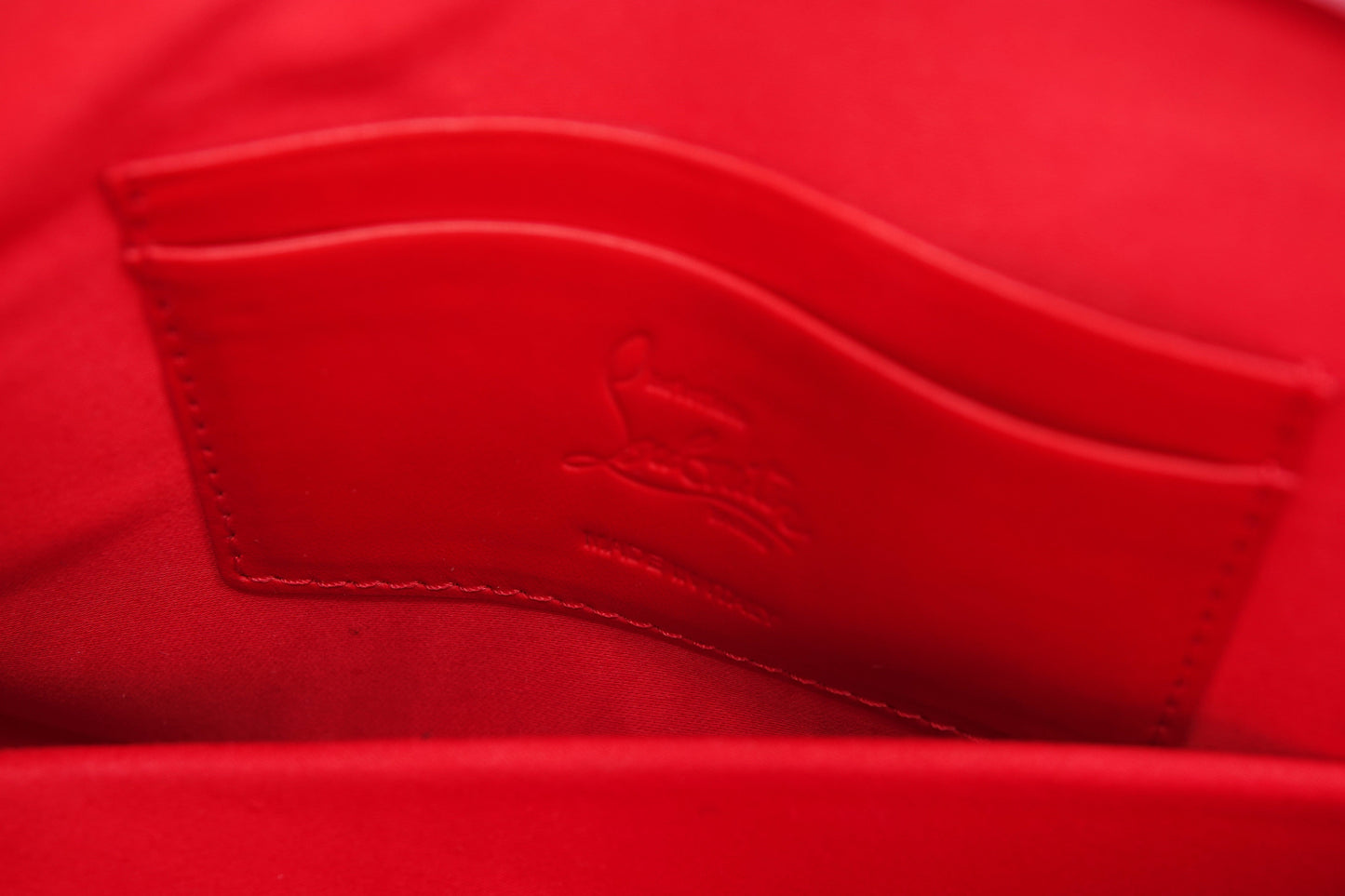 Close-up of a red fabric with a brand logo on a matching red background