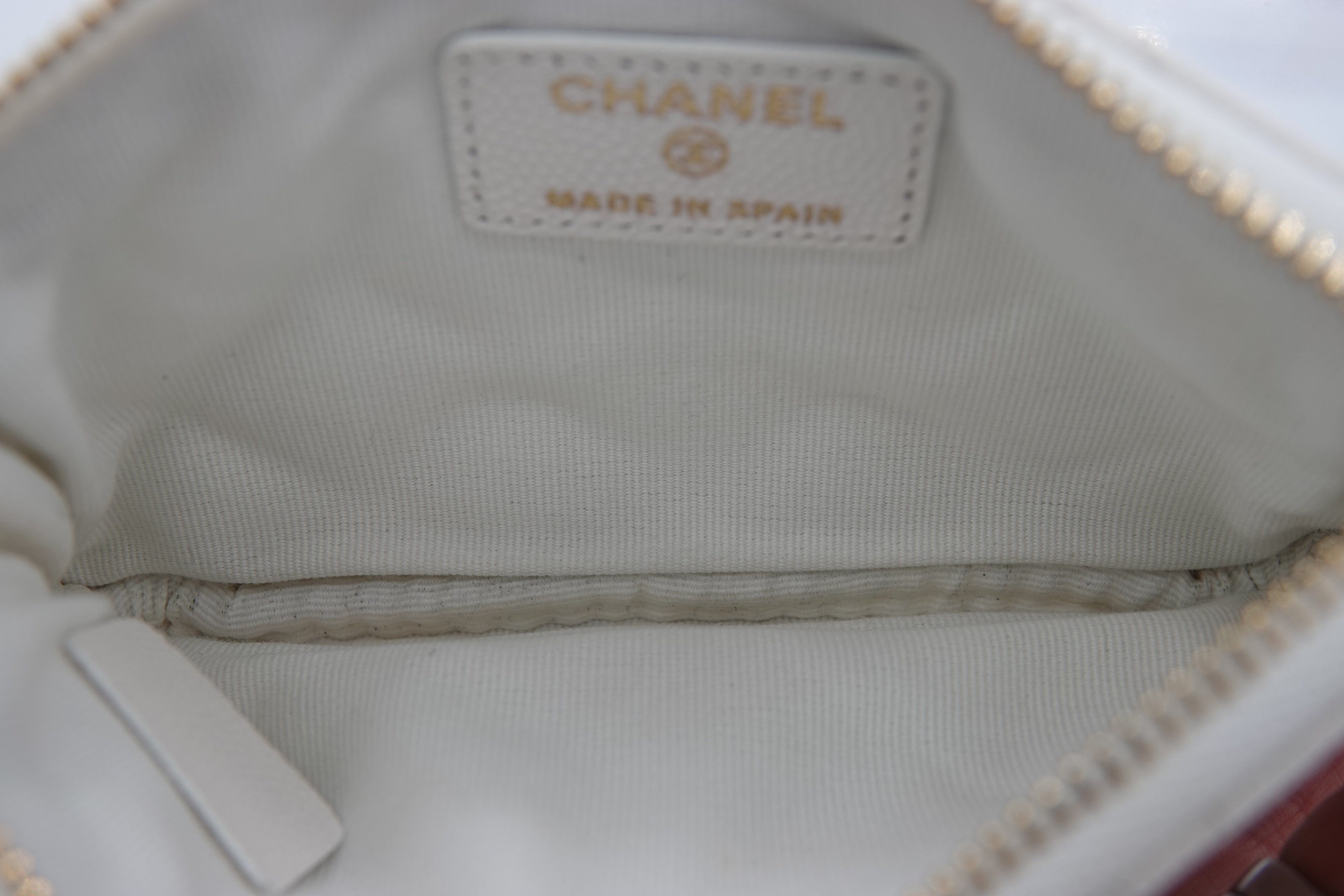 Close-up of a Chanel handbag with a visible logo and 'Made in Spain' text.