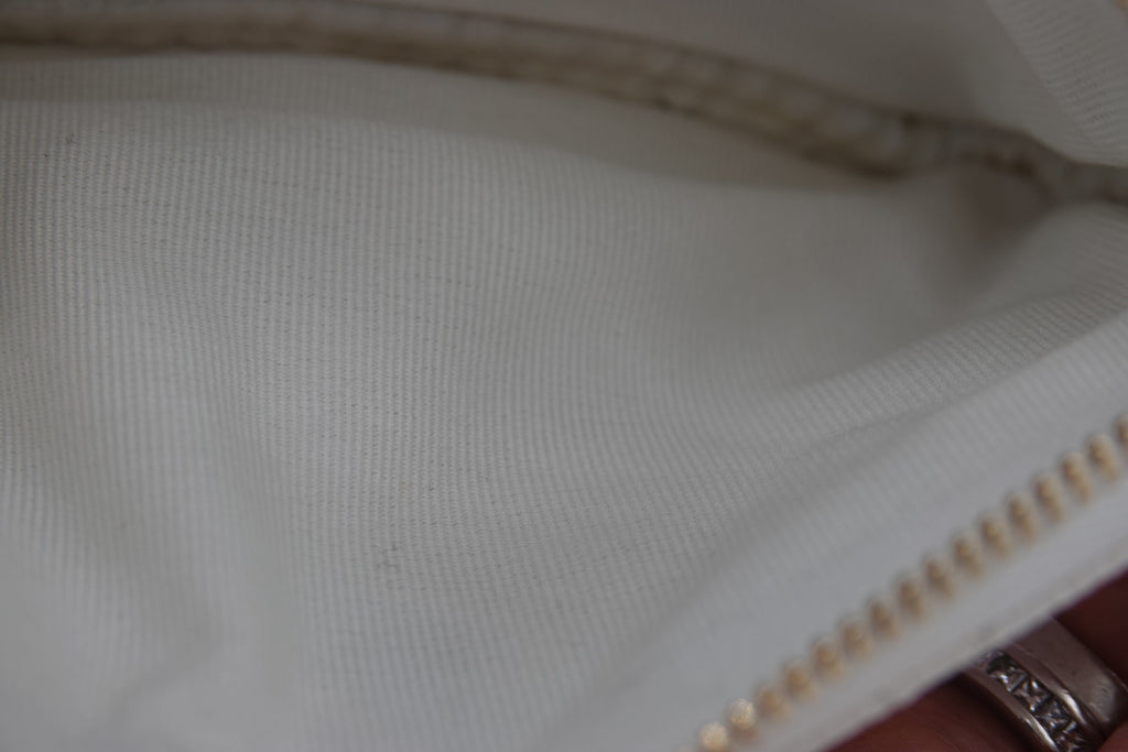 Close-up of a zipper on a white fabric background
