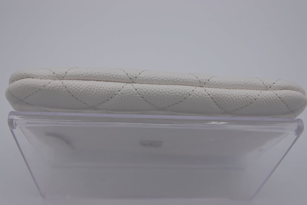 Quilted beige car seat cover on a clear plastic stand against a white background