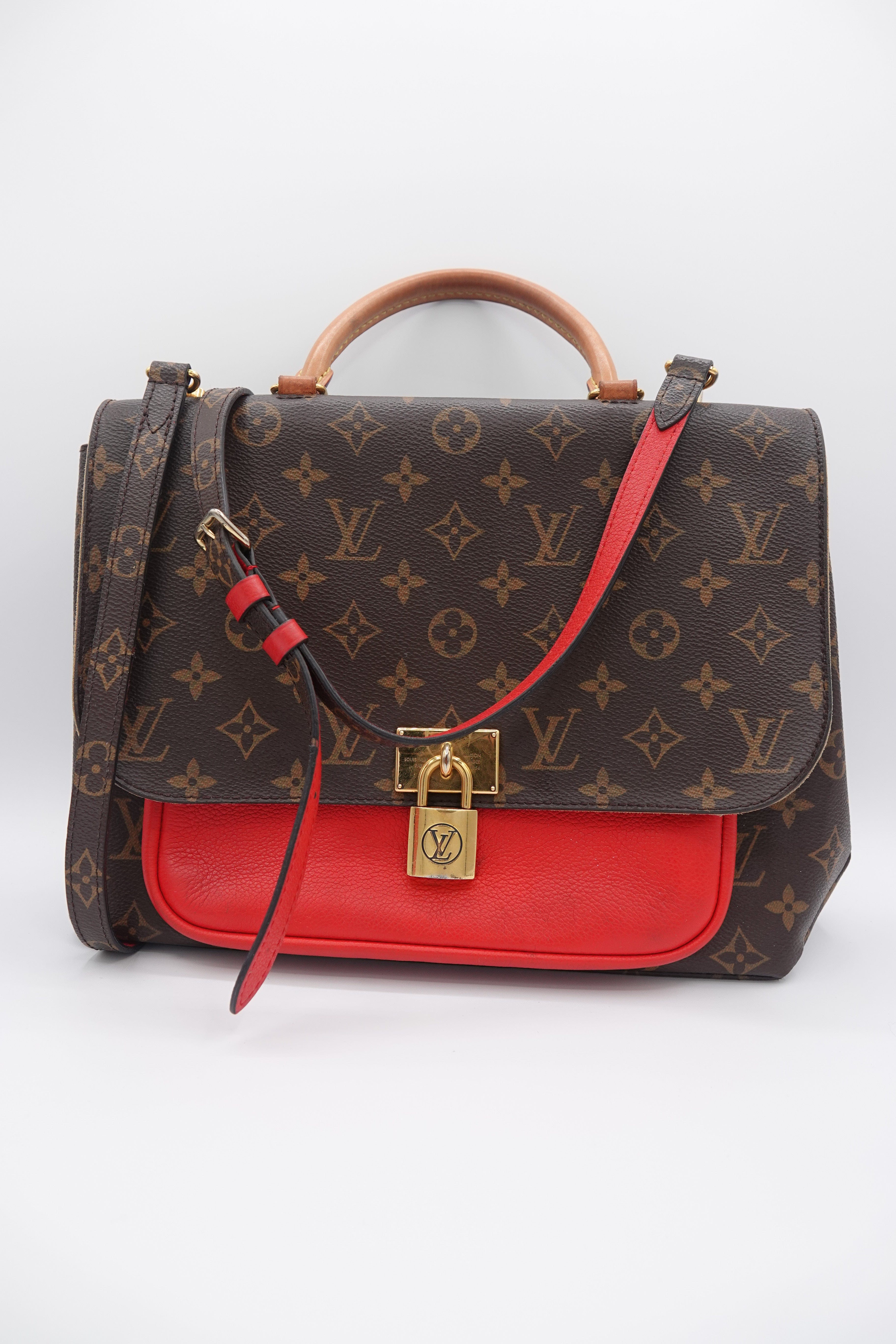Designer handbag with monogram pattern and red interior on a white background