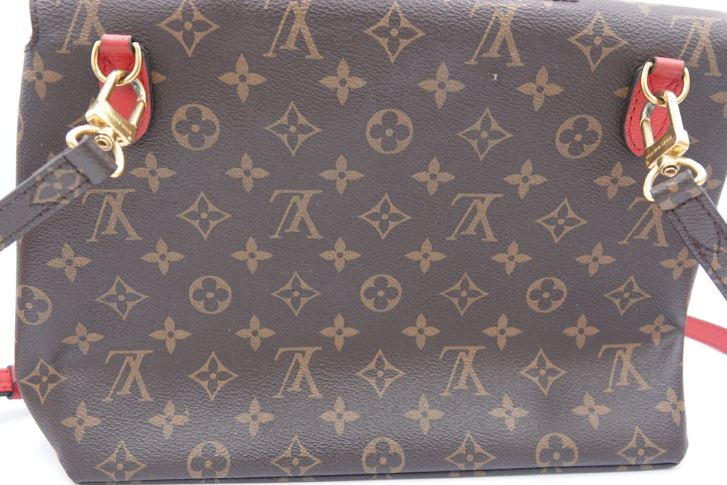 Designer handbag with monogram pattern on a white background