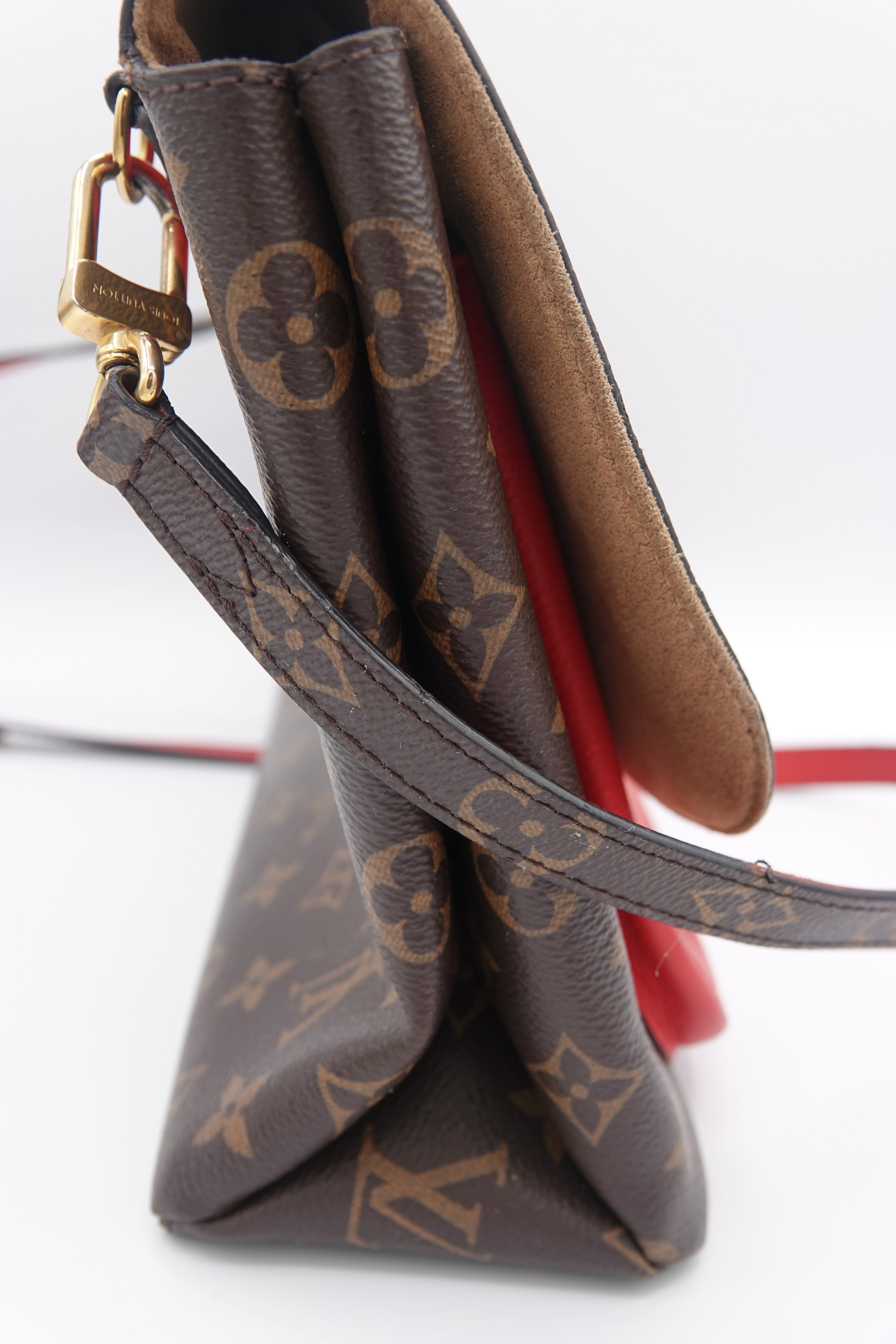 Louis Vuitton monogram handbag with strap on a white background