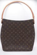 Brown handbag with a prominent pattern on a white background
