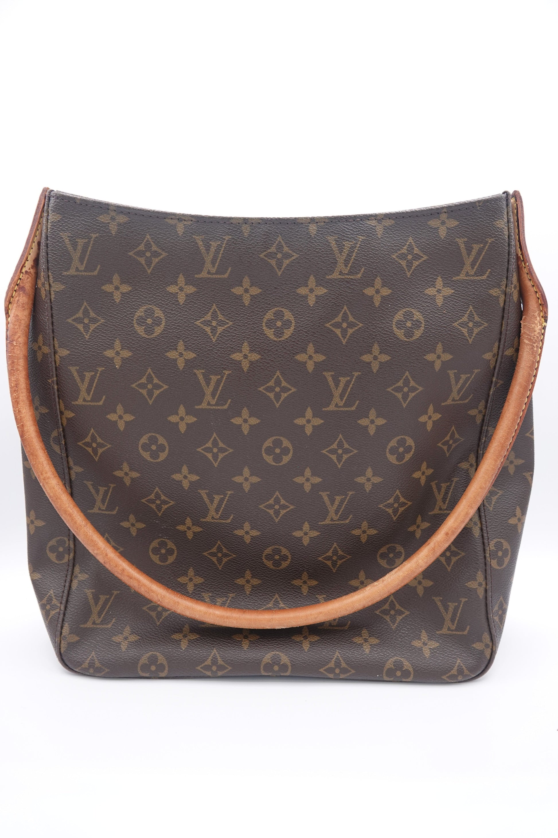 Louis Vuitton monogram patterned pouch with brown leather trim on a white background