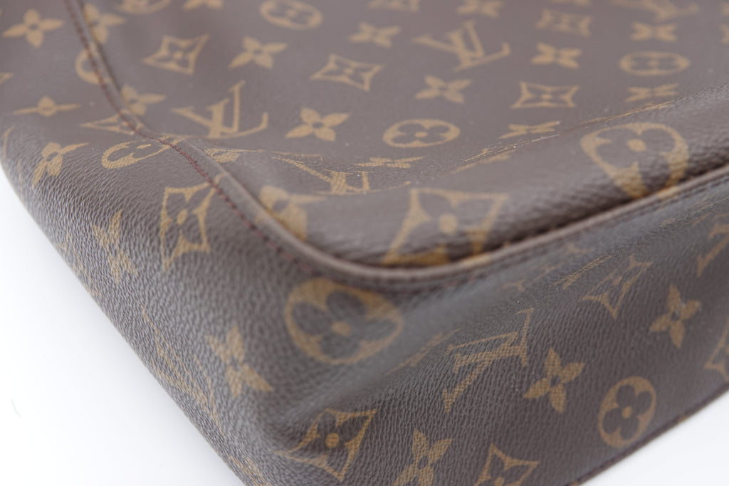 Close-up of a brown leather Louis Vuitton bag with monogram pattern.