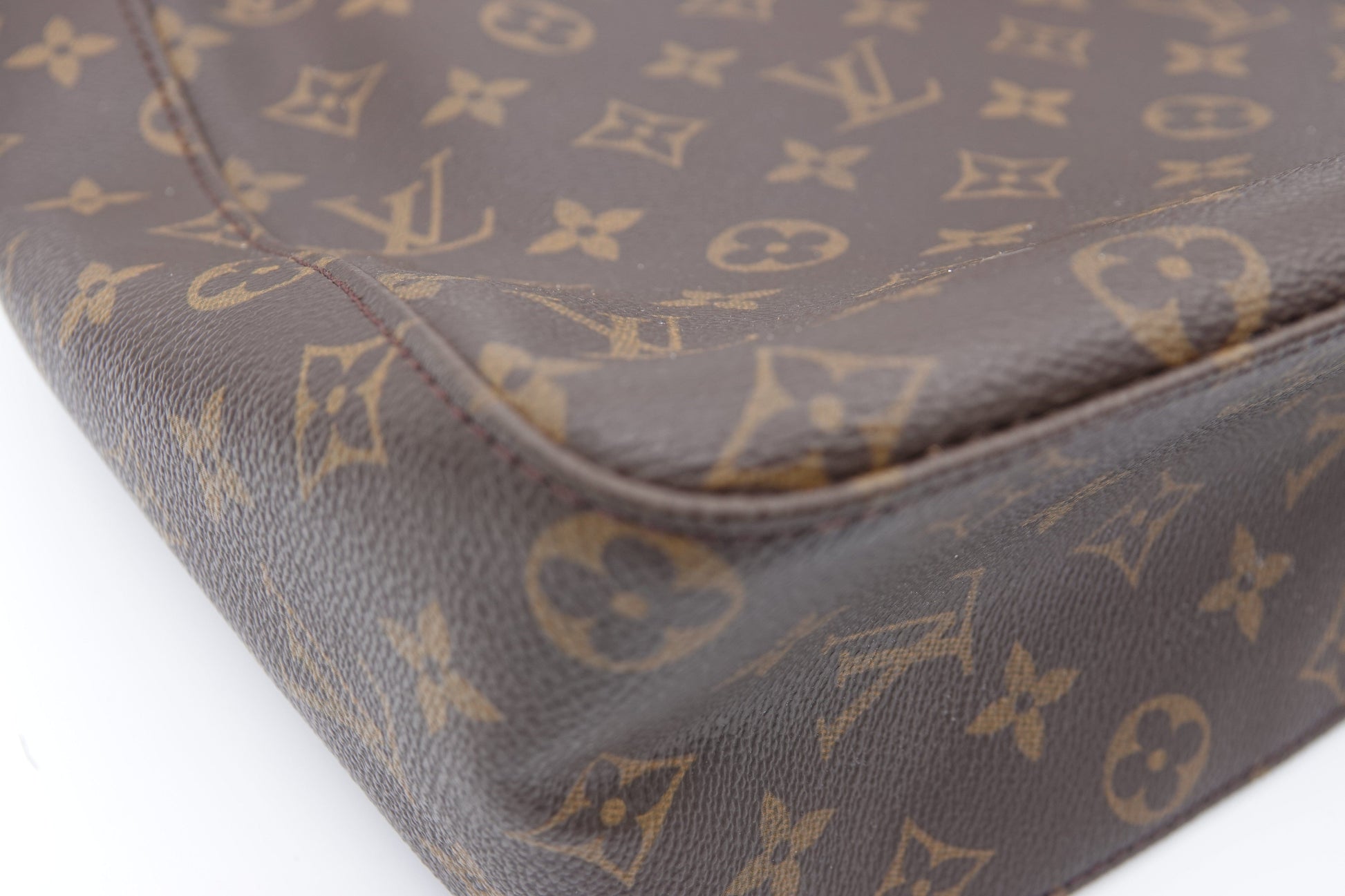 Close-up of a brown leather Louis Vuitton bag with monogram pattern.