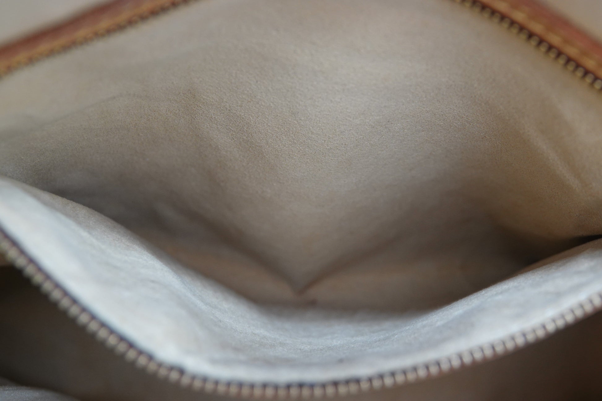 Close-up of a beige fabric surface with a zipper