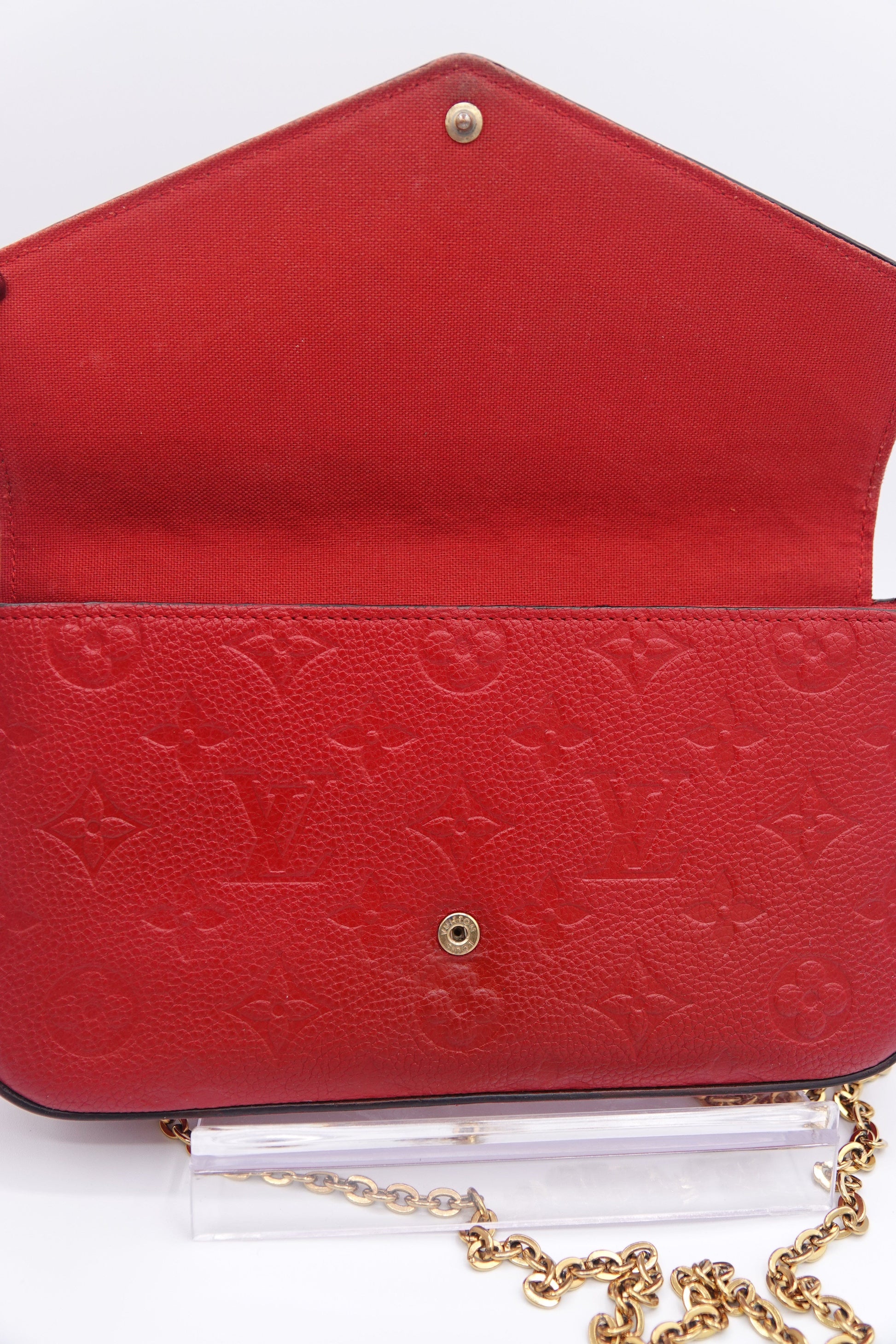 Red handbag with gold chain on a white background