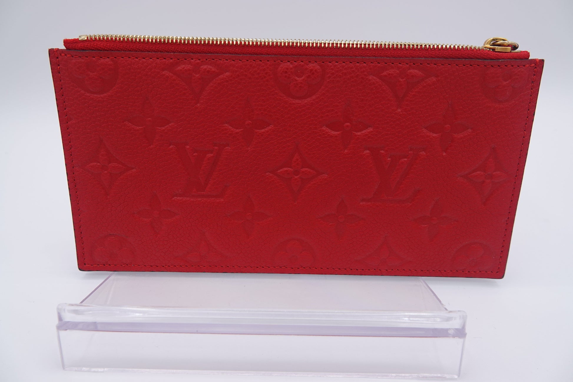 Red wallet with a brand logo on a white background