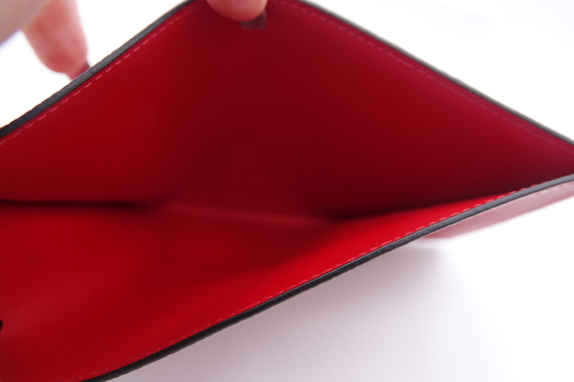 Close-up of a red interior of a wallet on a white background