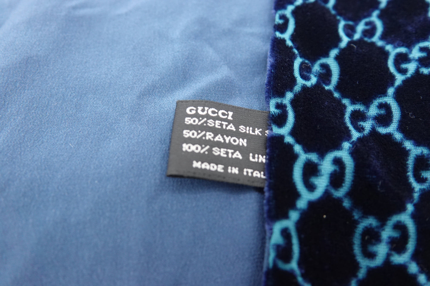 Gucci fabric label on a blue and black patterned fabric