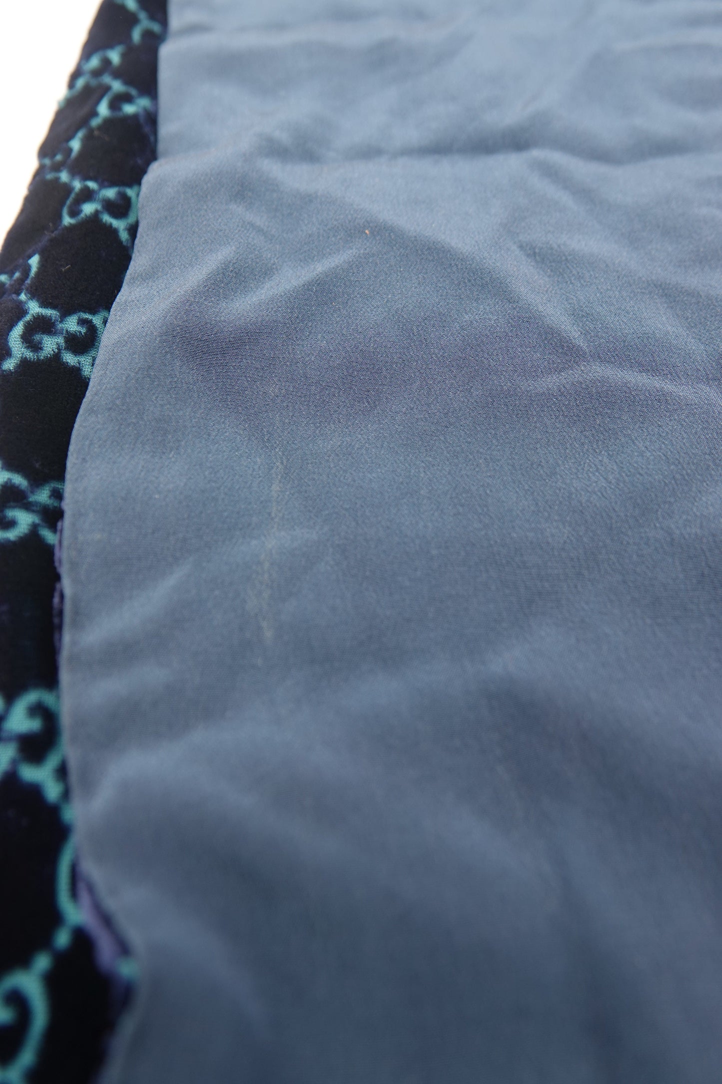 Close-up of blue fabric with a patterned border