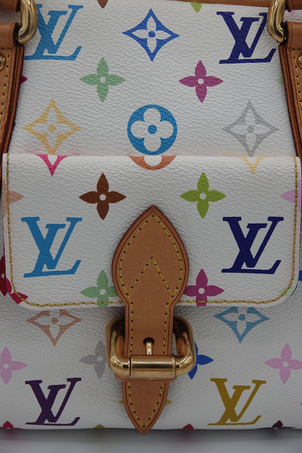 Designer handbag with colorful monogram pattern and brown leather strap.