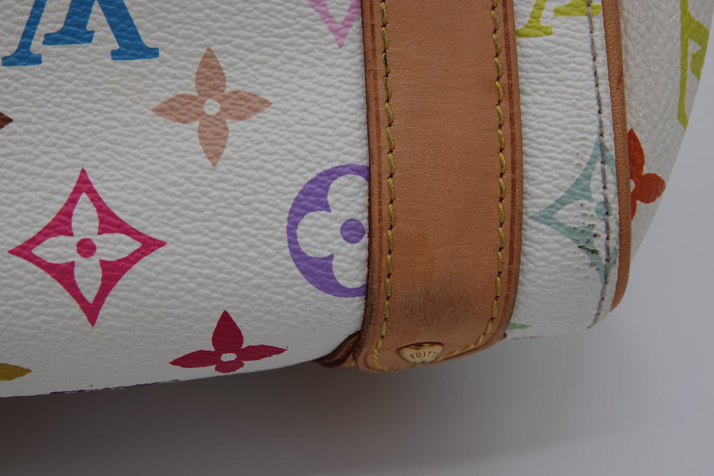 Close-up of a Louis Vuitton bag with multicolor monogram pattern and brown leather trim.