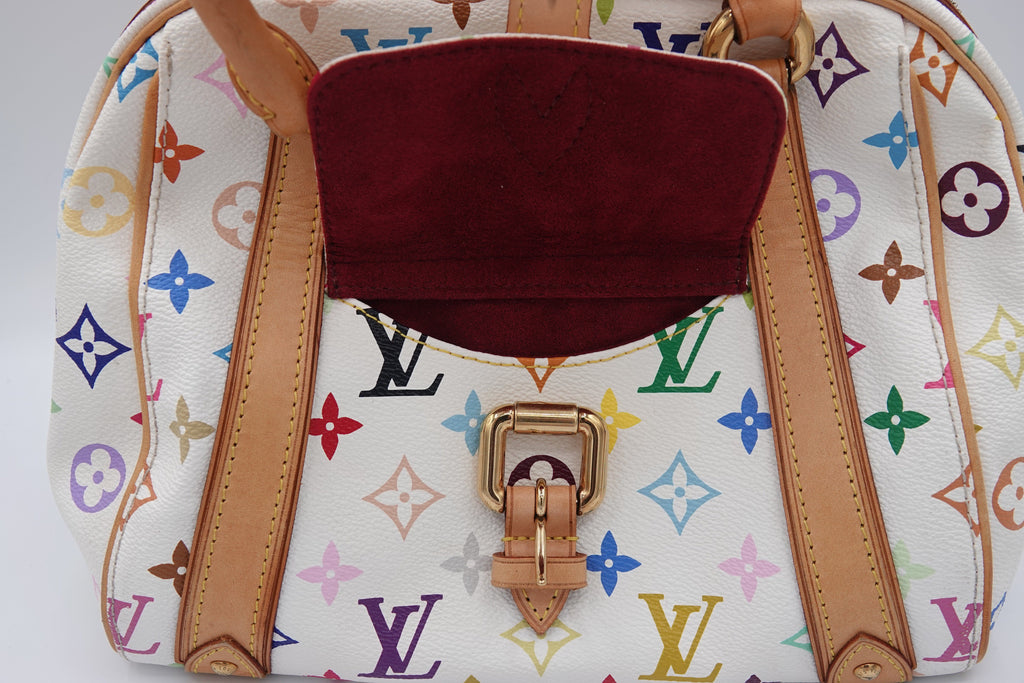 Designer handbag with multicolor logo pattern and brown leather accents